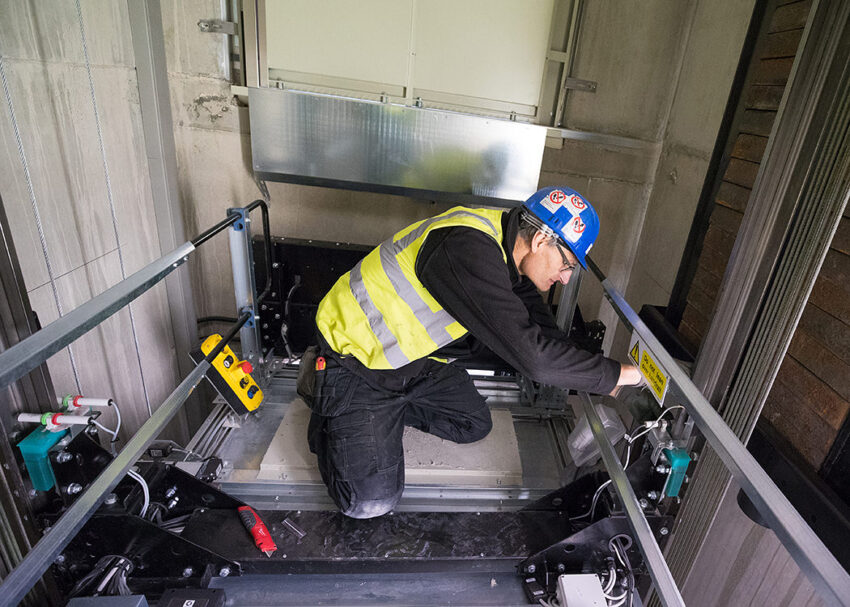 Lift Installation Lincoln Transport Hub for Willmott Dixon, Lift engineer on top of lift car