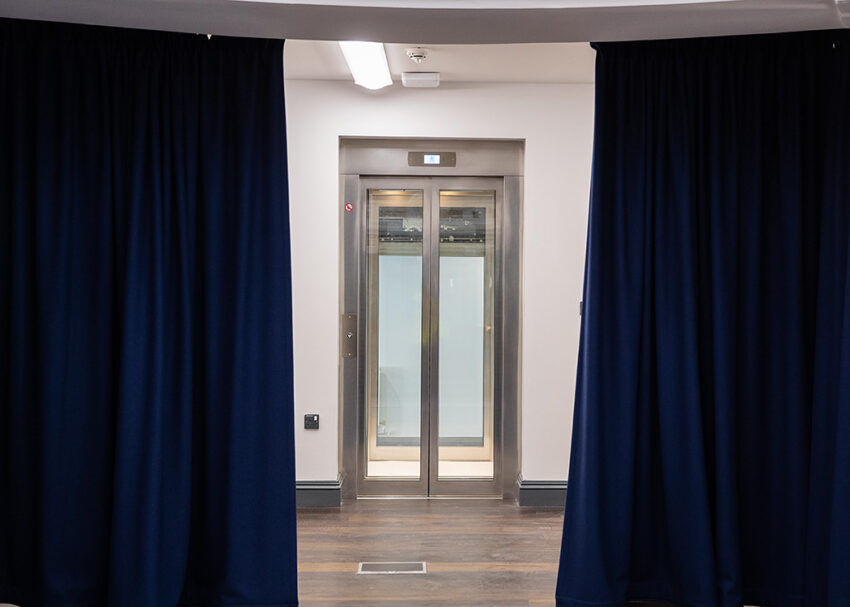 Glass Lift Installation Nottingham Trent University, University Hall, lift exit onto stage behind curtains