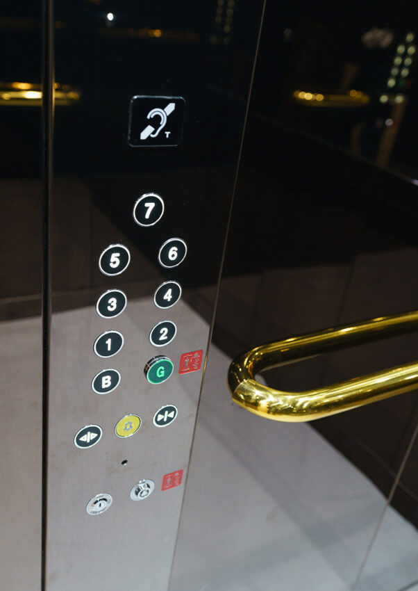 lift control button and gold lift handrails